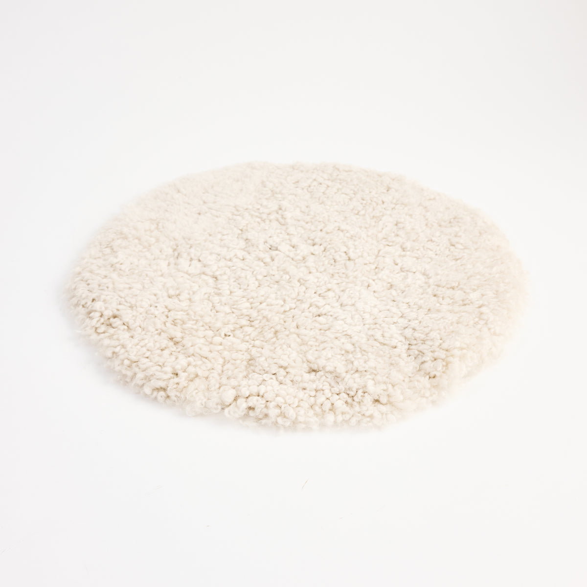 Short Wool Curly Sheepskin Seat Cover on a white background at Addison West