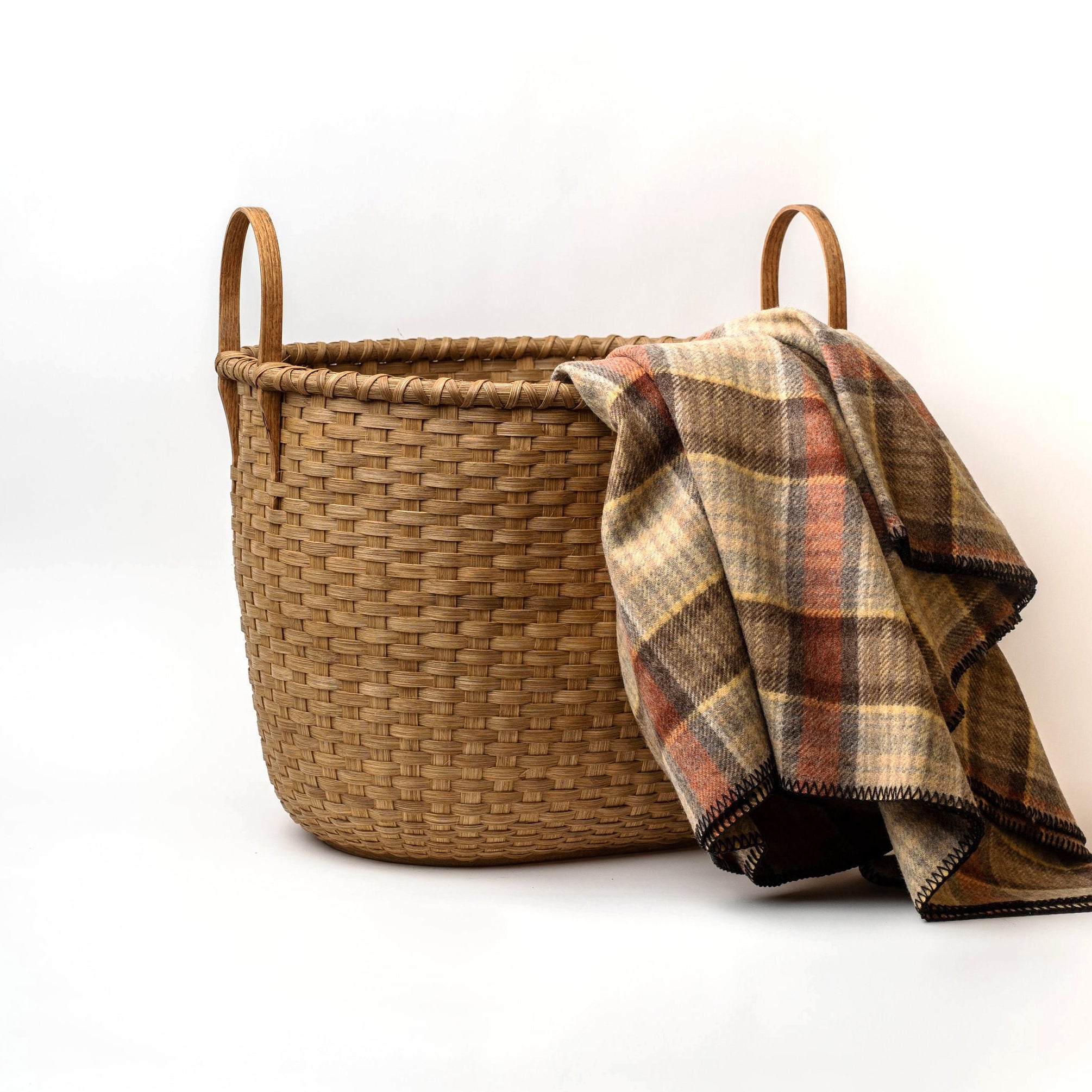 Vermont Wood Basket - Large on a white background with a blanket at Addison West