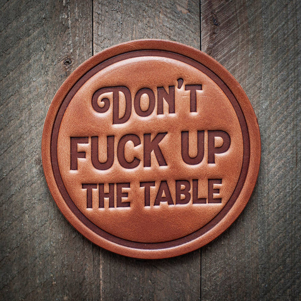 Don't F*ck up the Table Leather Coaster on a wood surface