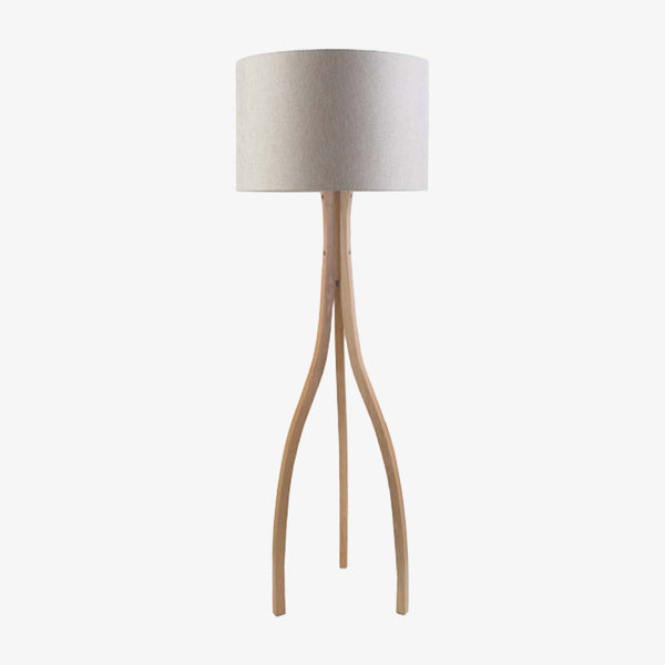 Surya Duxbury wood floor lamp wirh three legs and large linen barrel shade on a white background