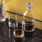 Simon Pearce Echo Lake Whiskey Glass, Set of 2 on a wood table at Addison West