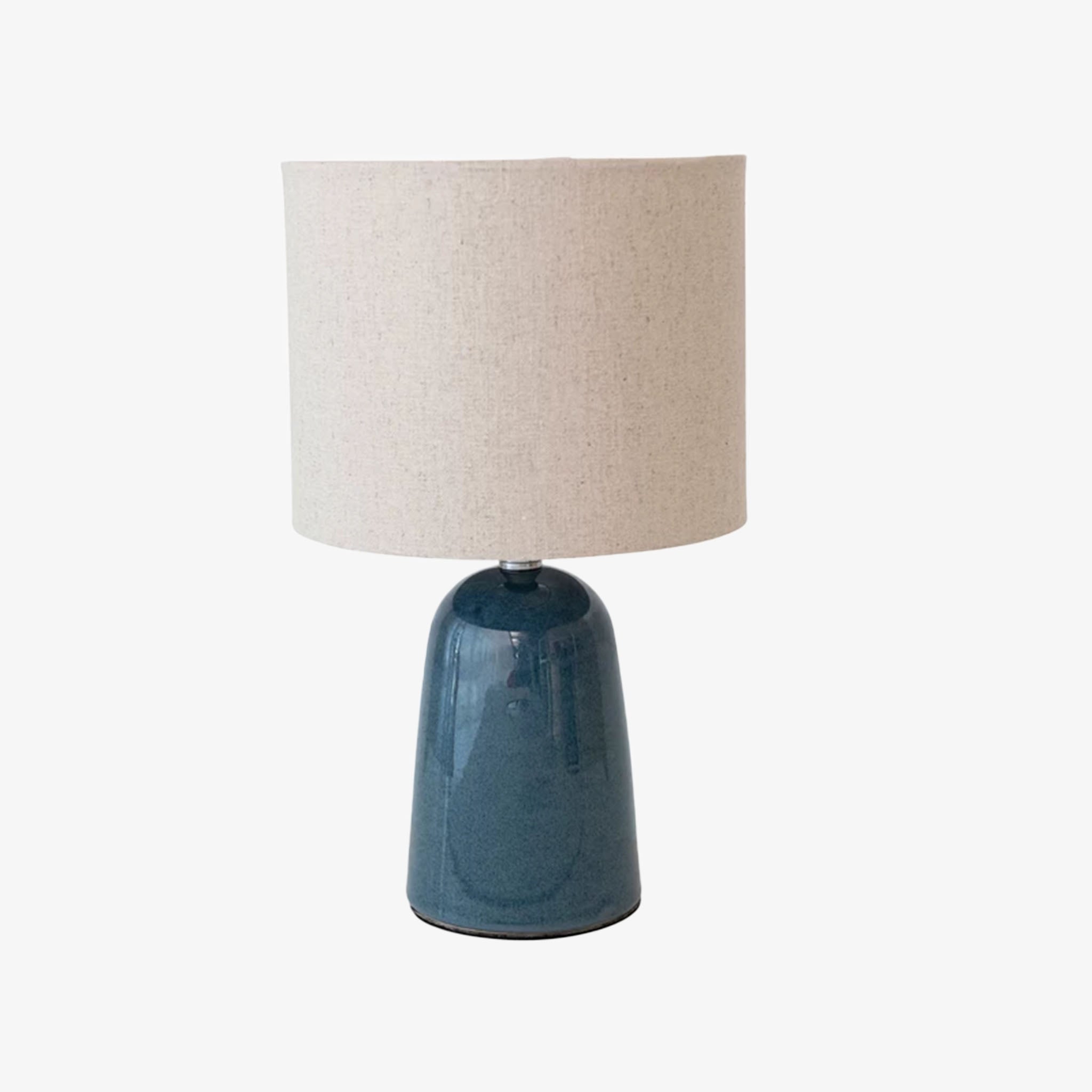 Small blue ceramic lamp with linen shade