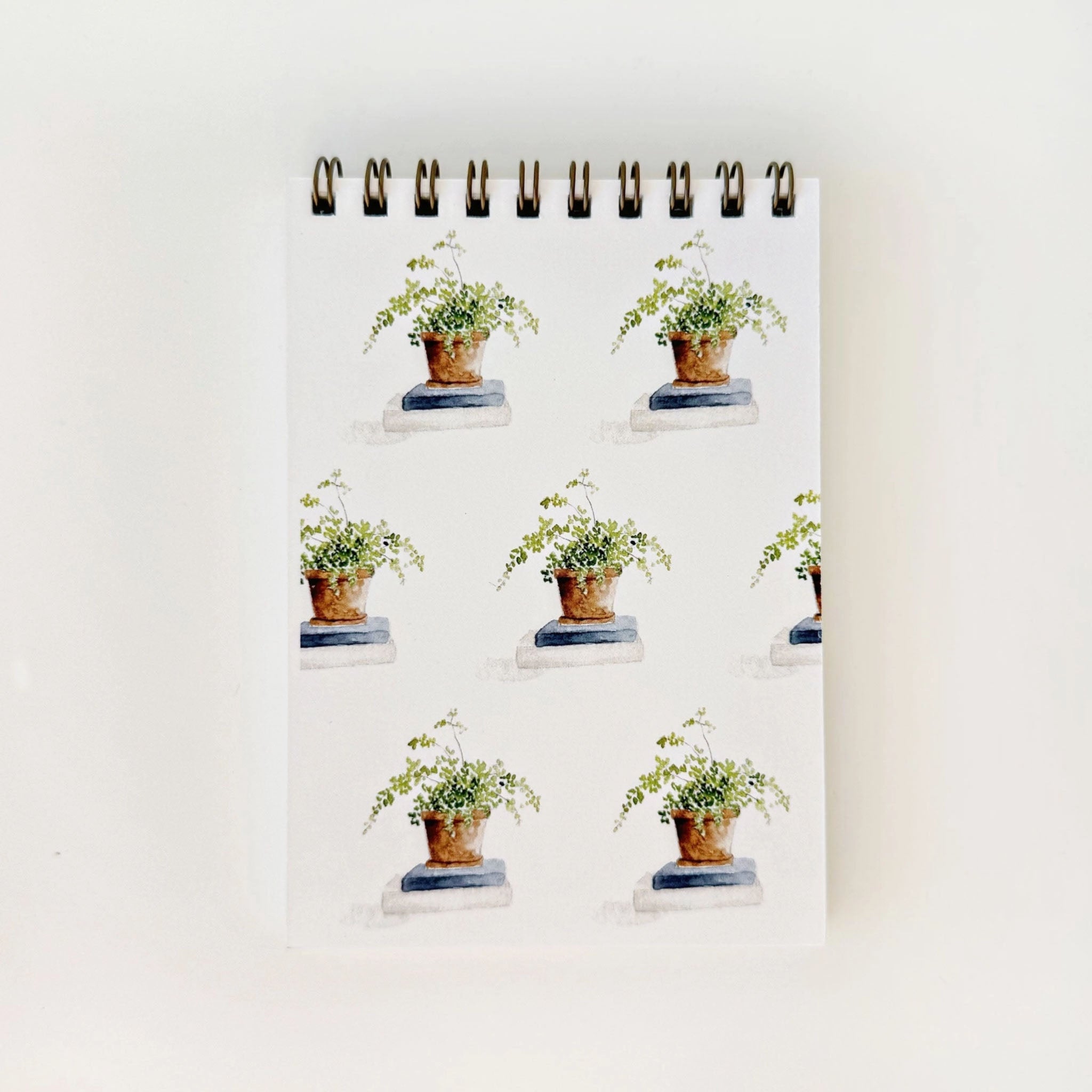 Notebook with potted plant design on a white background