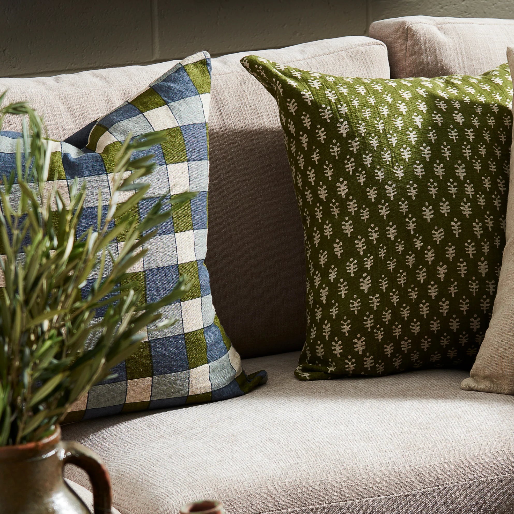 Ezra Earth Pillow on a sofa at Addison West