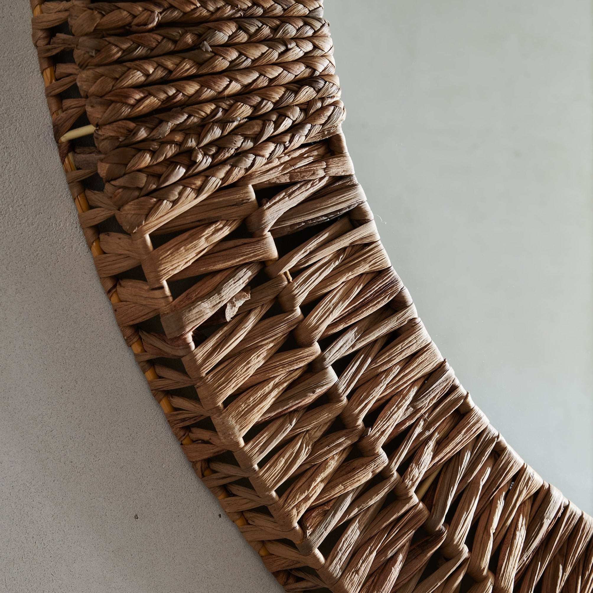 Close up of Folha Round Mirror in Natural on a beige background at Addison West