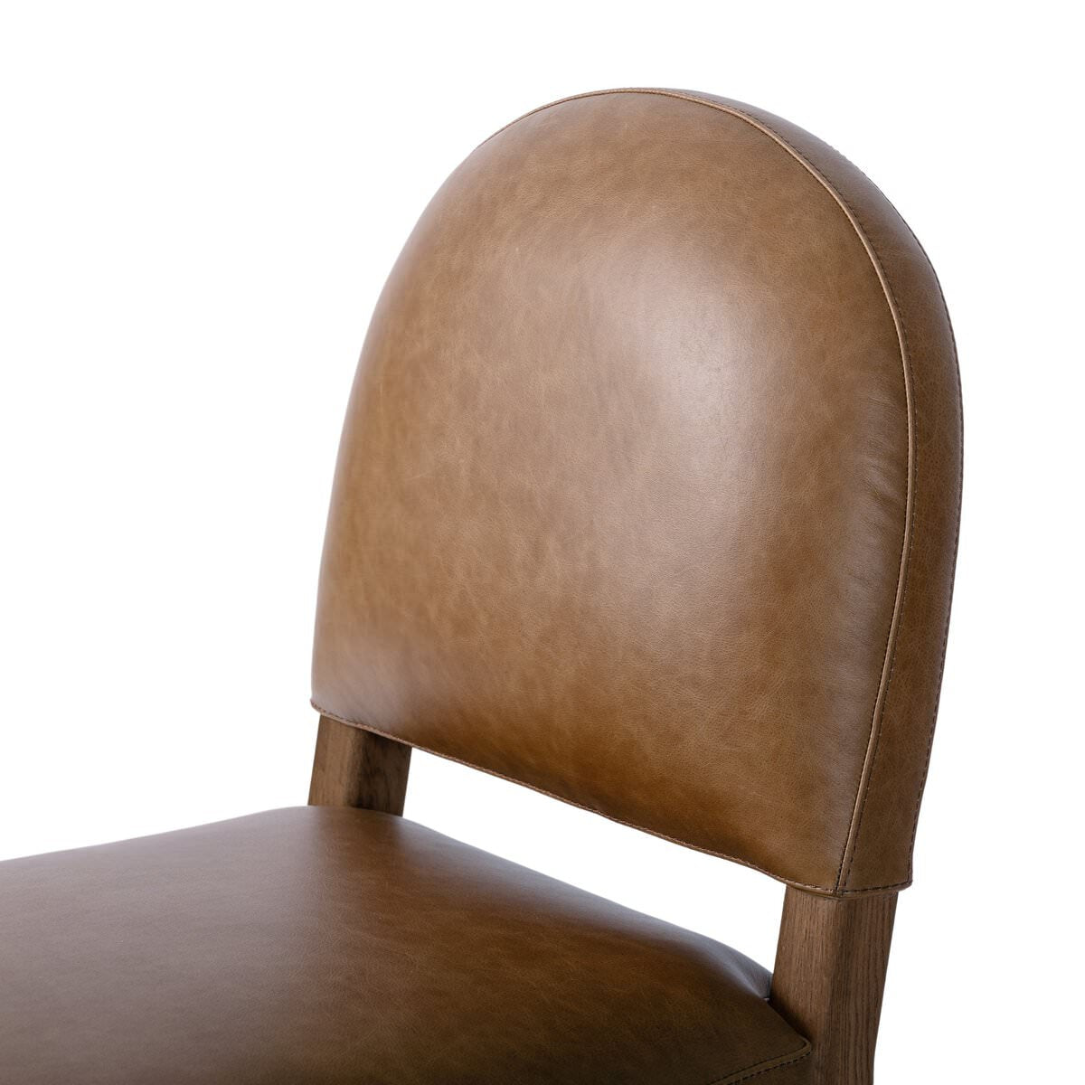 Close up of Four Hands Abilene Dining Chair in Chaps Saddle on a white background at Addison West