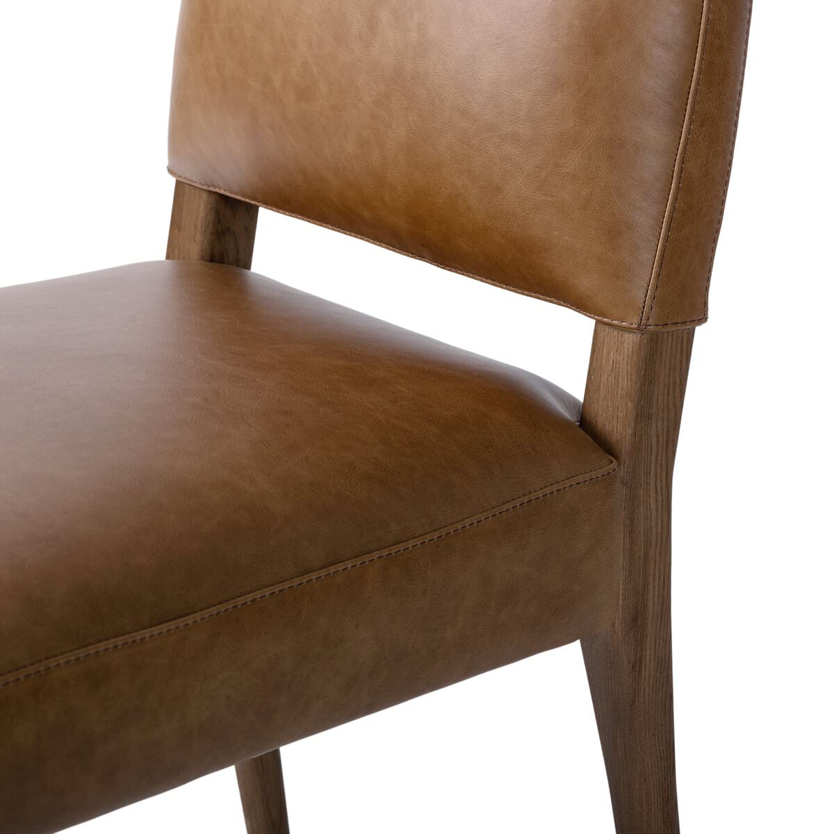 Close up of Four Hands Abilene Dining Chair in Chaps Saddle on a white background at Addison West