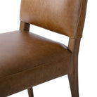 Close up of Four Hands Abilene Dining Chair in Chaps Saddle on a white background at Addison West