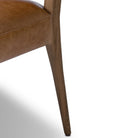 Close up of Four Hands Abilene Dining Chair in Chaps Saddle on a white background at Addison West