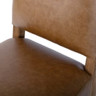 Close up of Four Hands Abilene Dining Chair in Chaps Saddle on a white background at Addison West