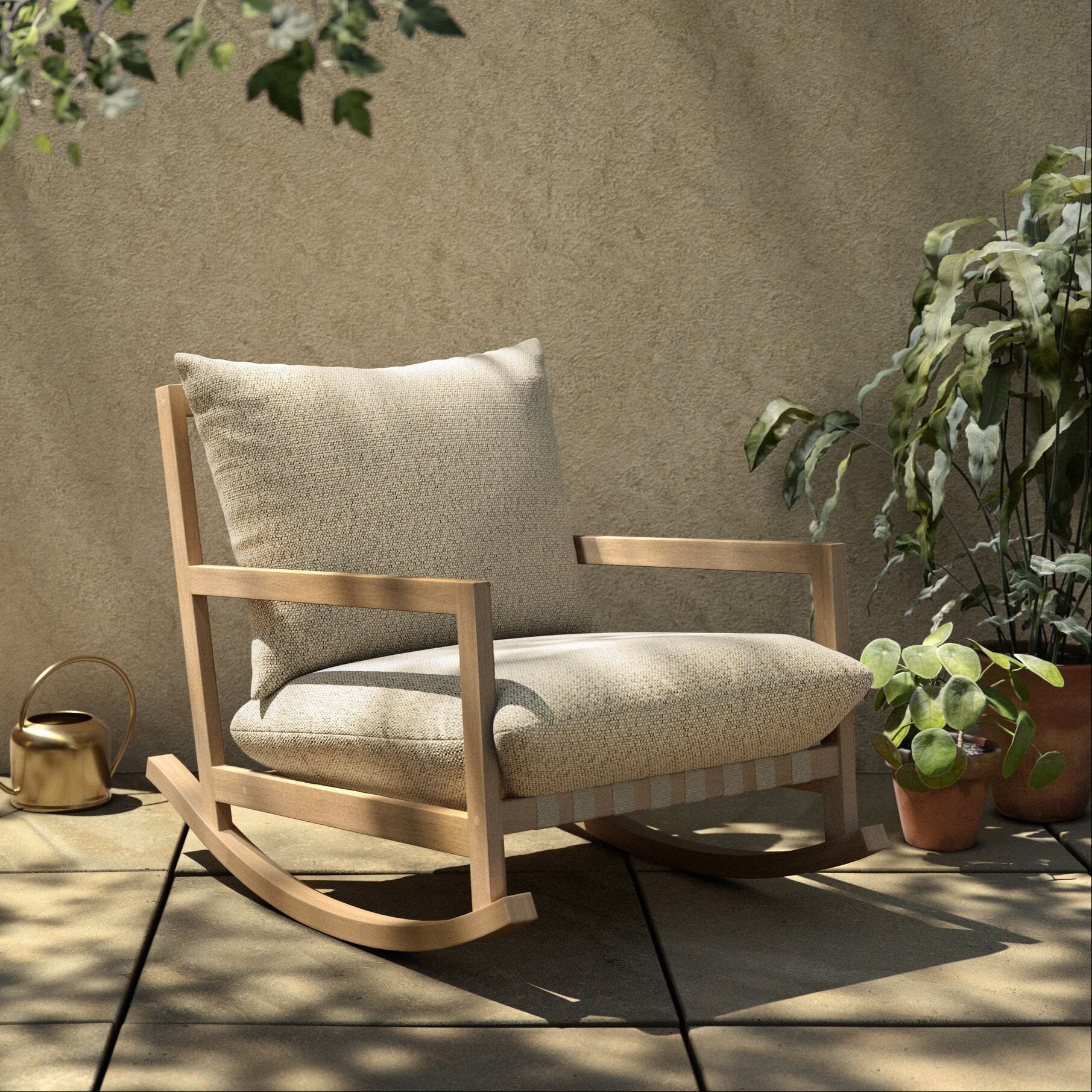 Four Hands Aiken Outdoor Rocking Chair in Faye Sand on a patio at Addison West
