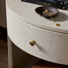 Close up of Four Hands Amelia Oval One Drawer Nightstand in Ivory Painted Linen in a bedroom at Addison West
