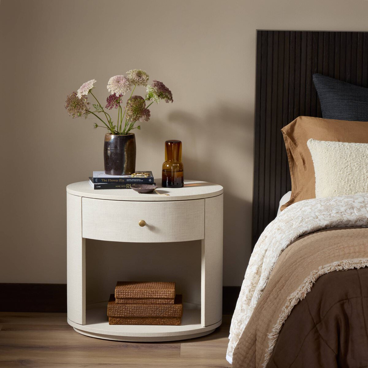Four Hands Amelia Oval One Drawer Nightstand in Ivory Painted Linen in a bedroom at Addison West
