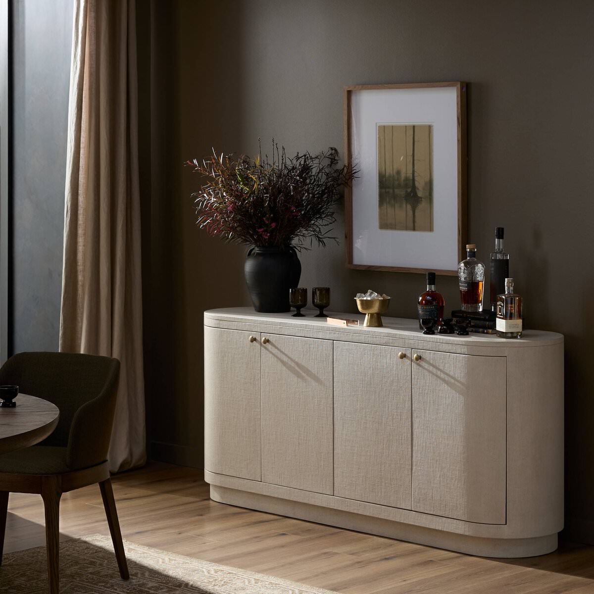 Four Hands Amelia Sideboard in Ivory Painted Linen in a dark green dining room at Addison West