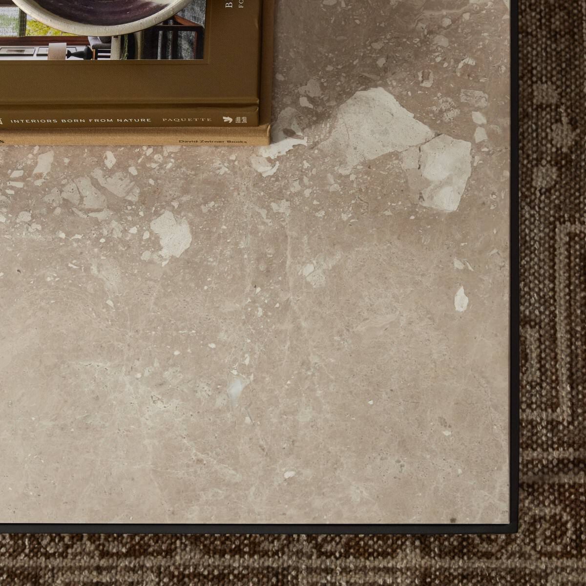 Top of Four Hands Babylon Coffee Table in Lunar Marble against a rug at Addison West