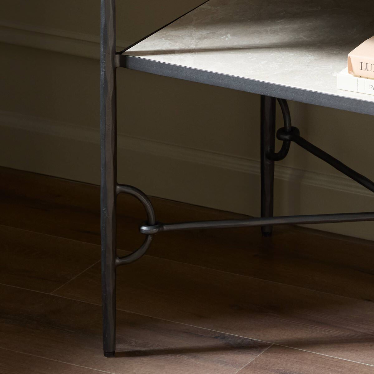 Close up of Four Hands Babylon Nightstand in Hammered Gunmetal in a green bedroom at Addison West