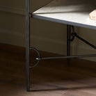 Close up of Four Hands Babylon Nightstand in Hammered Gunmetal in a green bedroom at Addison West