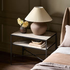 Four Hands Babylon Nightstand in Hammered Gunmetal in a green bedroom at Addison West