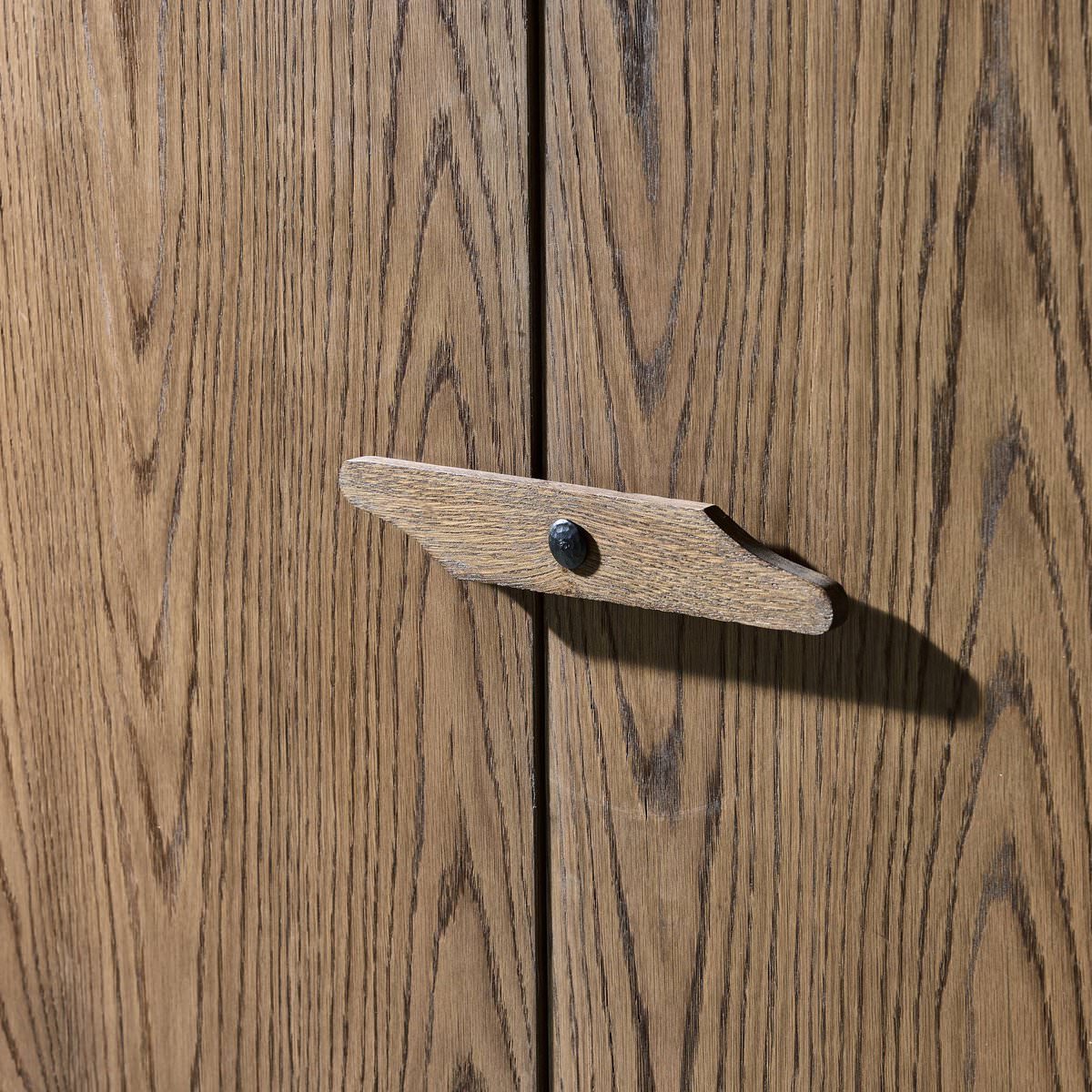 Close up of Four Hands Bedford Cabinet in Warm Natural Oak Veneer in a living room at Addison West