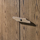 Close up of Four Hands Bedford Cabinet in Warm Natural Oak Veneer in a living room at Addison West