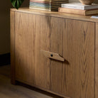 Close up of Four Hands Bedford Media Console in Warm Natural Oak Veneer in a living room at Addison West