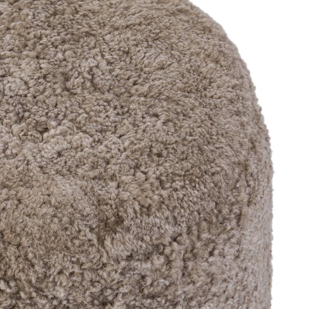 Close up of Four Hands Bilbury Ottoman in Taupe Shearling on a white background at Addison West