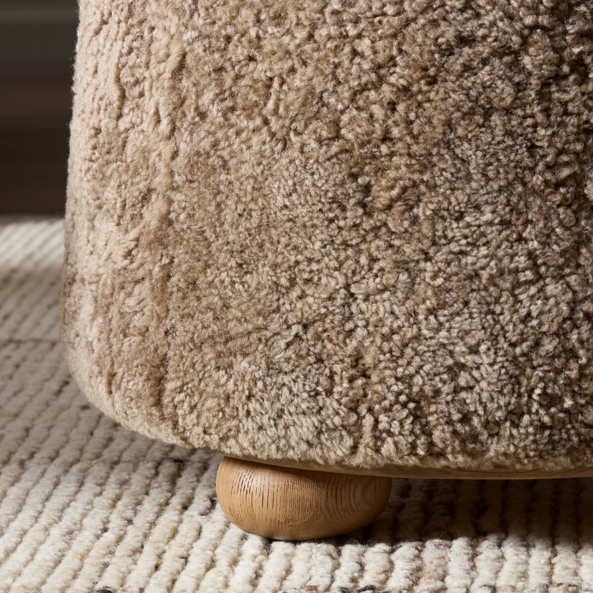 Close up of Four Hands Bilbury Ottoman in Taupe Shearling on a white background at Addison West