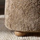 Close up of Four Hands Bilbury Ottoman in Taupe Shearling on a white background at Addison West