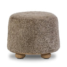 Four Hands Bilbury Ottoman in Taupe Shearling on a white background at Addison West