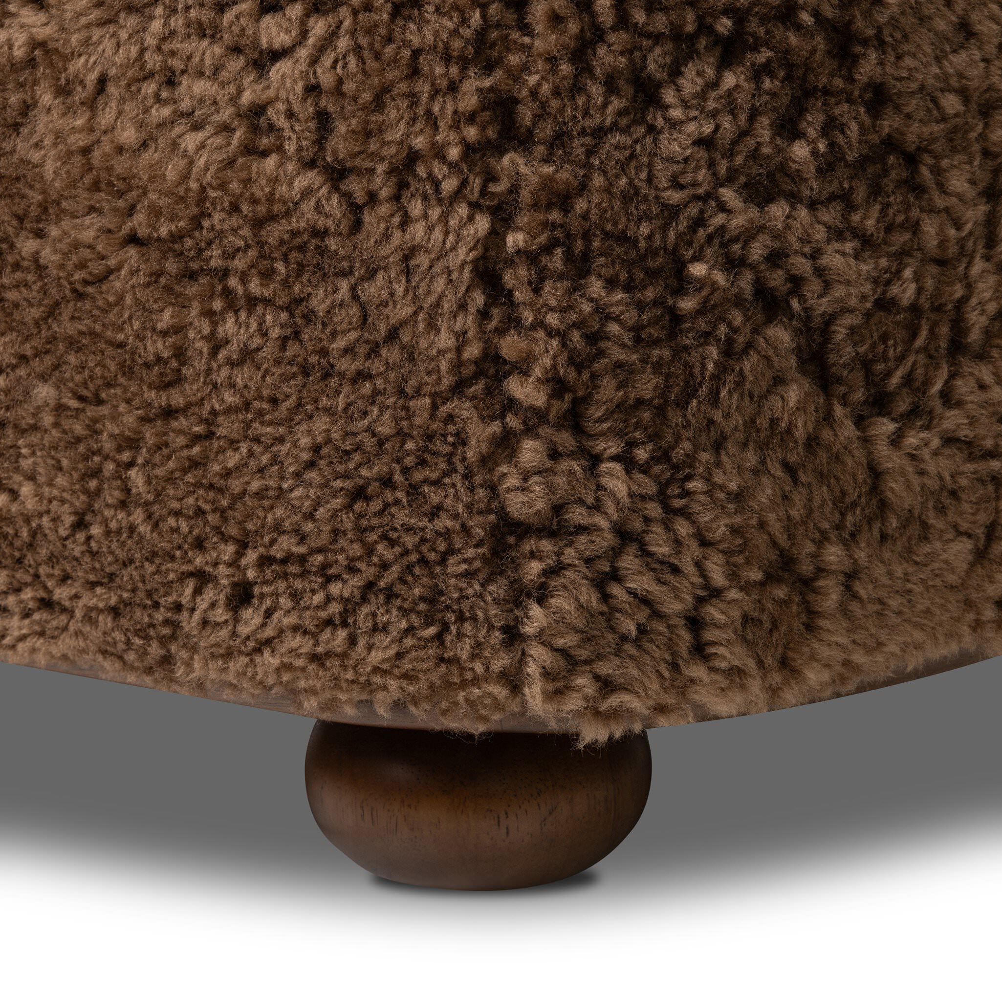 Four Hands Bilbury Oval Ottoman in Amber Shearling on white background at Addison West.