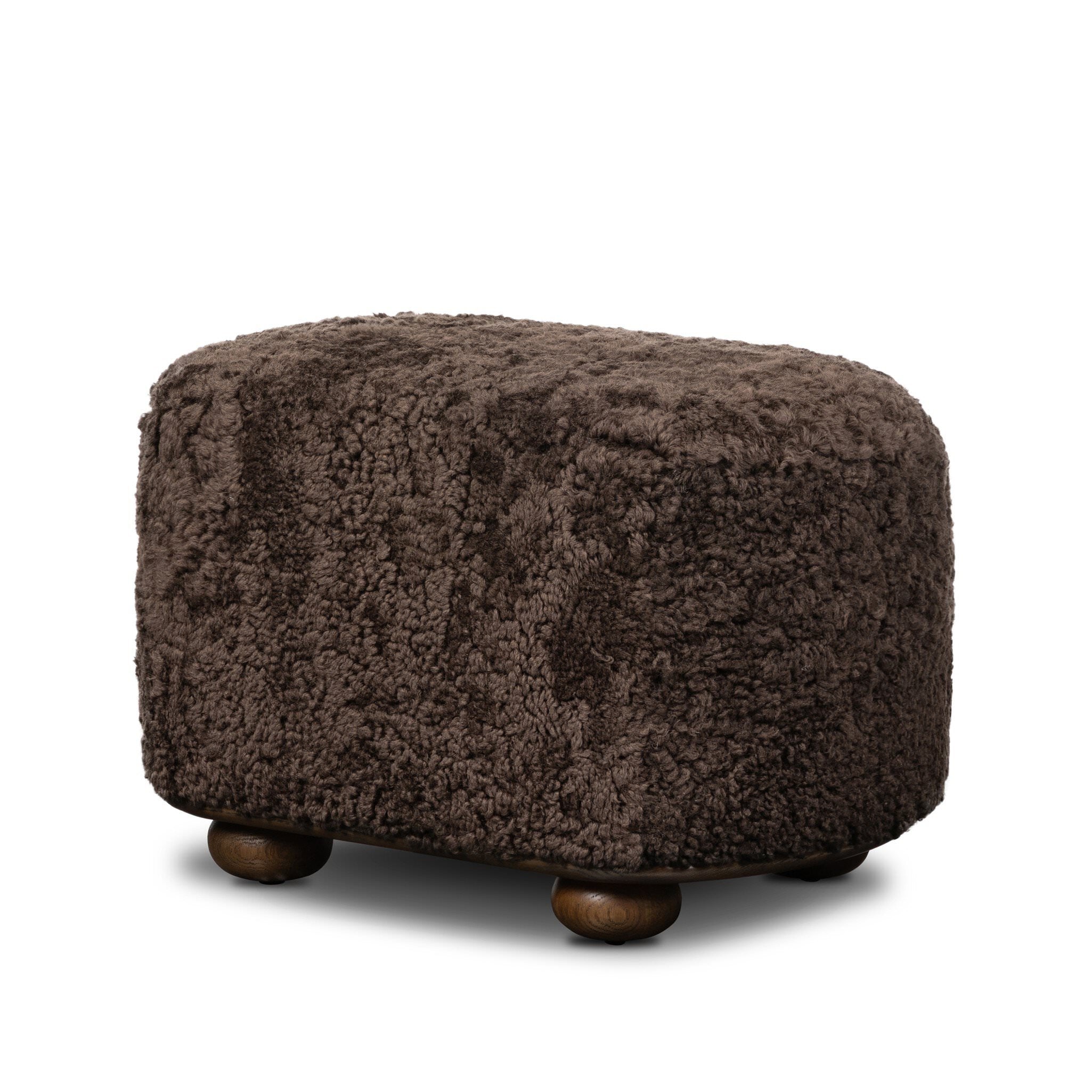 Four Hands Bilbury Oval Ottoman in Cocoa Shearling on white background at Addison West.