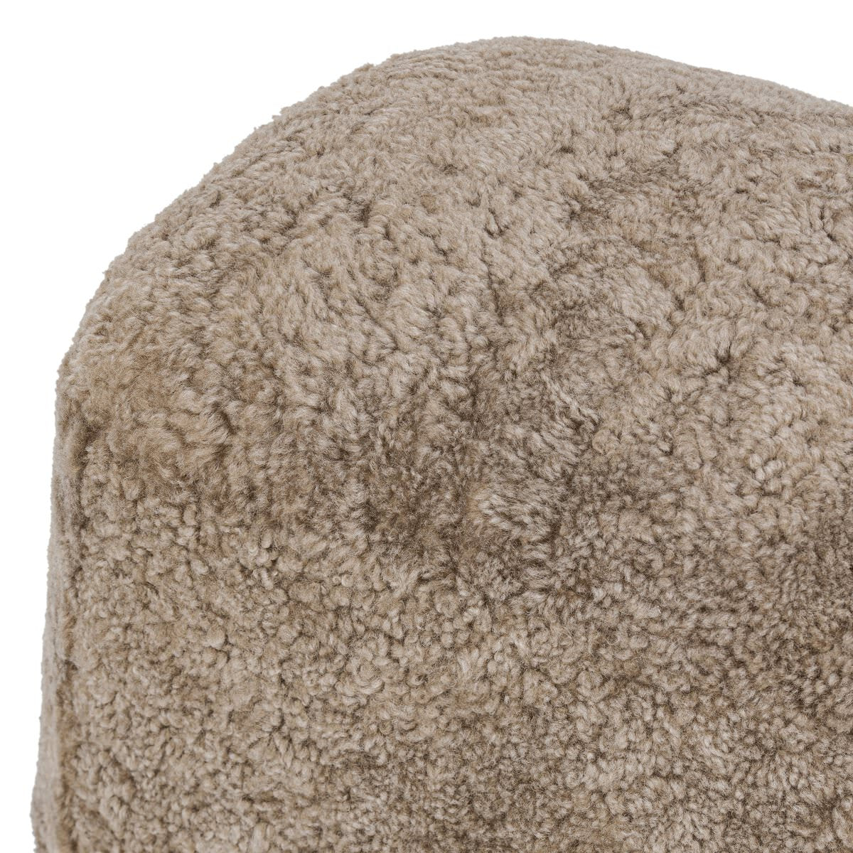 Close up of Four Hands Bilbury Oval Ottoman in Taupe Shearling on a white background at Addison West