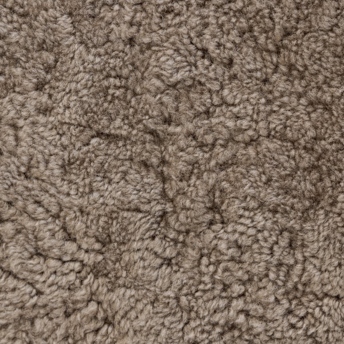Close up of Four Hands Bilbury Oval Ottoman in Taupe Shearling on a white background at Addison West