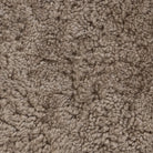 Close up of Four Hands Bilbury Oval Ottoman in Taupe Shearling on a white background at Addison West