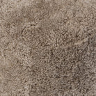 Close up of Four Hands Bilbury Oval Ottoman in Taupe Shearling on a white background at Addison West