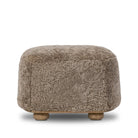 Four Hands Bilbury Oval Ottoman in Taupe Shearling on a white background at Addison West
