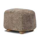 Four Hands Bilbury Oval Ottoman in Taupe Shearling on a white background at Addison West