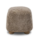 Four Hands Bilbury Oval Ottoman in Taupe Shearling on a white background at Addison West