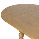 Close up of Four Hands Blinn Oval Leaf Extension Dining Table 88"-127" in Worn Oak Veneer on a white background at Addison West