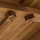 Close up of Four Hands Blinn Oval Leaf Extension Dining Table 88"-127" in Worn Oak Veneer on a white background at Addison West