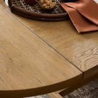 Close up of Four Hands Blinn Oval Leaf Extension Dining Table 88"-127" in Worn Oak Veneer in a dining room at Addison West