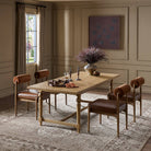 Four Hands Blinn Oval Leaf Extension Dining Table 88"-127" in Worn Oak Veneer in a beige dining room at Addison West