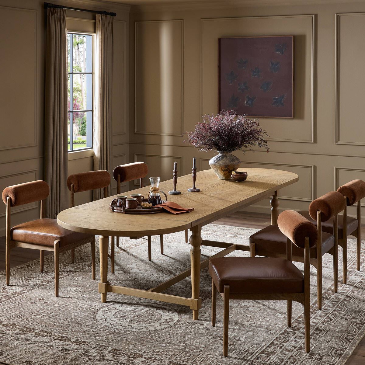 Four Hands Blinn Oval Leaf Extension Dining Table 88"-127" in Worn Oak Veneer in a beige dining room at Addison West
