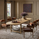 Four Hands Blinn Oval Leaf Extension Dining Table 88"-127" in Worn Oak Veneer in a beige dining room at Addison West