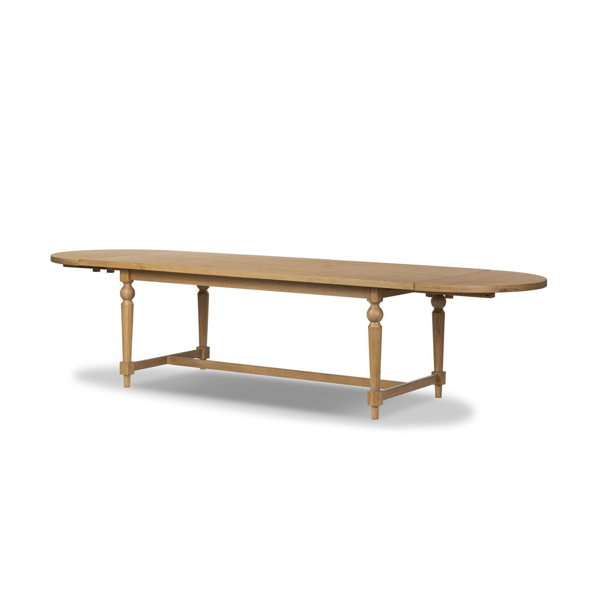 Four Hands Blinn Oval Leaf Extension Dining Table 88"-127" in Worn Oak Veneer on a white background at Addison West