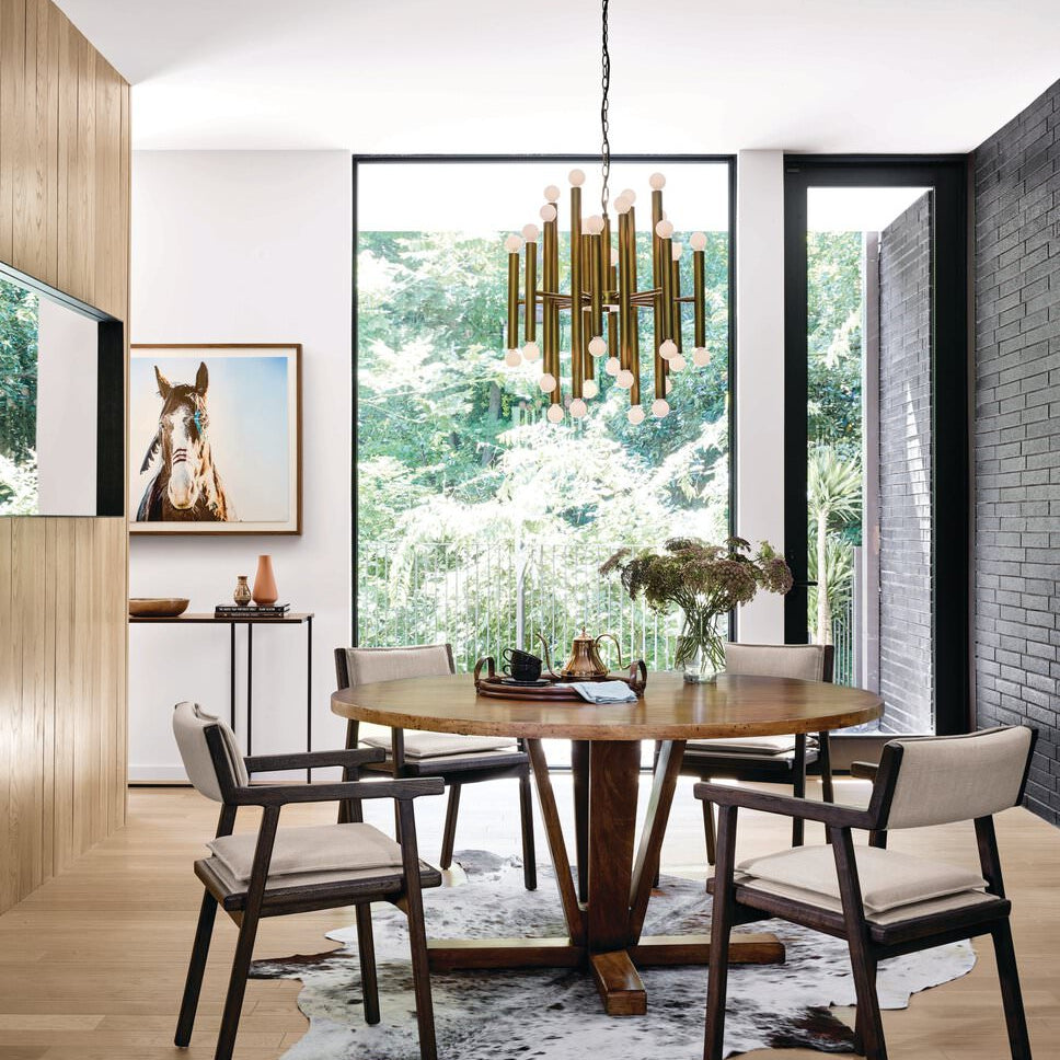 Four Hands Cobain Round 60" Dining Table in Reclaimed Mango in a modern dining room