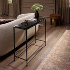 Four Hands Dalston Cast Glass Console Table in Smoked Black Cast Glass in a living room at Addison West