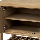 Close up of Four Hands Dalton Media Console in Aged Natural Oak Veneer on a white background at Addison West