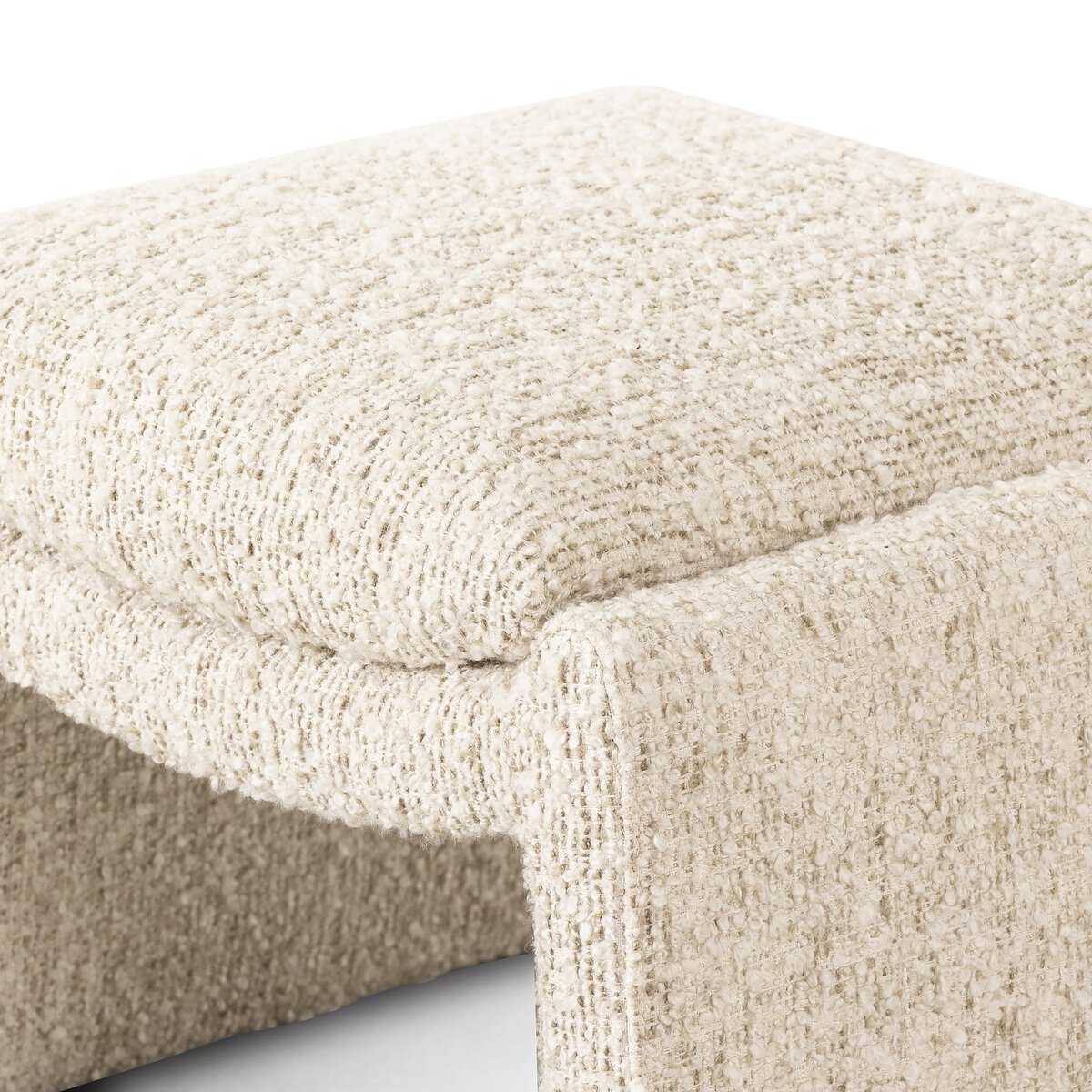 Close up of Four Hands Daniel Ottoman in Ivan Sand on a white background at Addison West