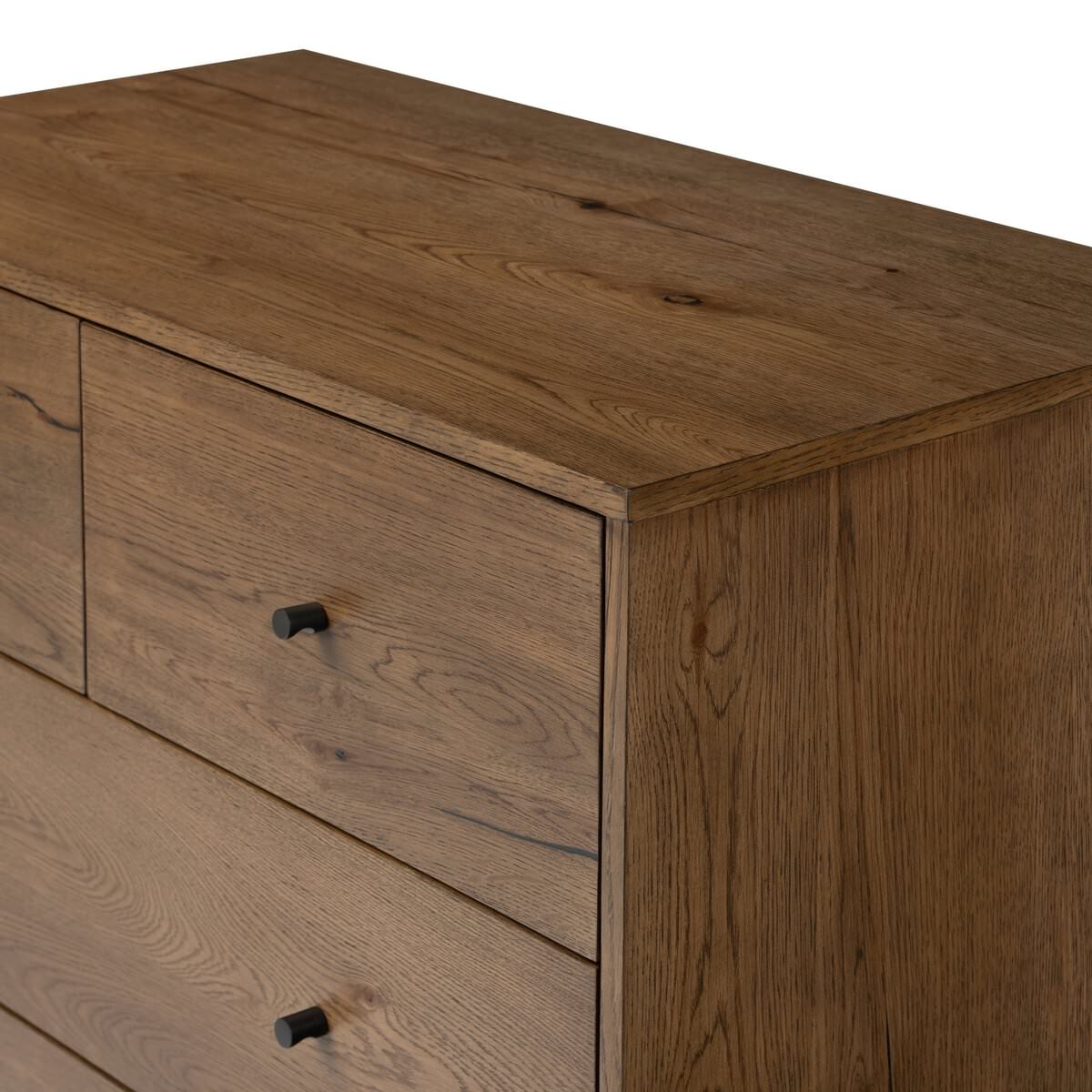 Close up of Four Hands Eaton 5 Drawer Dresser in Amber Oak Resin on a white background at Addison West